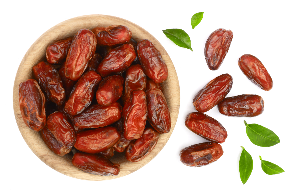 Dry,Dates,With,Green,Leaves,In,Wooden,Bowl,Isolated,On